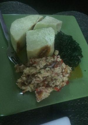 A picture of Boiled yam with egg sauce and vegetable.