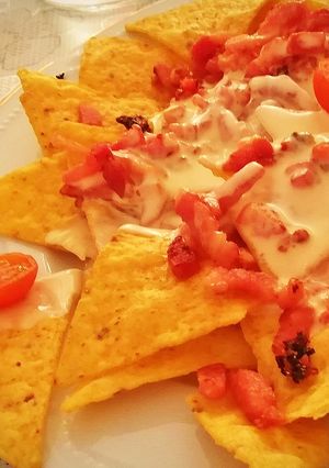A picture of Nacho Dip with Bacon and Melted Manchego Cheese.