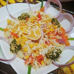 A picture of Boiled corn potatoes cheese chat.