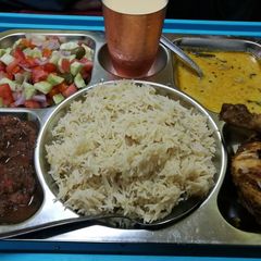 A picture of Chicken tikka zeera rice khati daal tammatercutni milkshak selad.