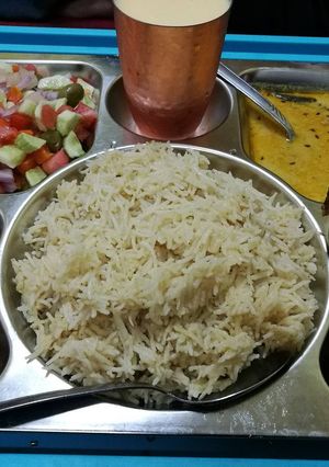 A picture of Chicken tikka zeera rice khati daal tammatercutni milkshak selad.