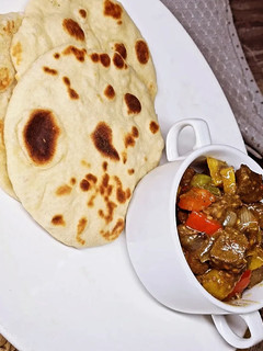 A picture of Liver sauce with Naan Bread.