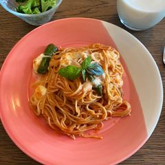 A picture of Simple tomato pasta with mozzarella and padron peppers.