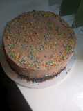 Pinacolada cake covered in chocolate whipped cream