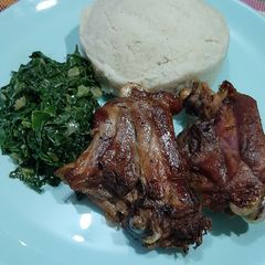 A picture of Fried chicken with steamed spinach.