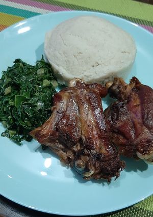 A picture of Fried chicken with steamed spinach.