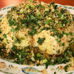 A picture of Roasted whole cauliflower with green tahini sauce.