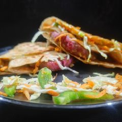 A picture of Tortilla wrap with beetroot tikki.