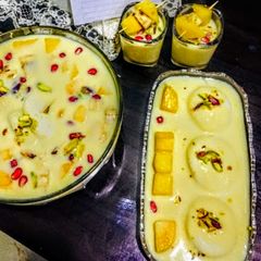 A picture of Mango rasmalai in mix fruit dry fruits vanilla custard.