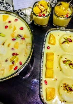 A picture of Mango rasmalai in mix fruit dry fruits vanilla custard.