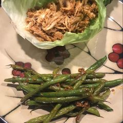A picture of Asian inspired lettuce wrap with green beans.
