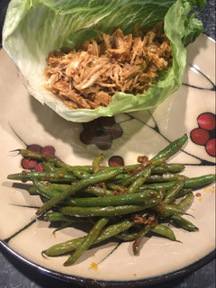 A picture of Asian inspired lettuce wrap with green beans.
