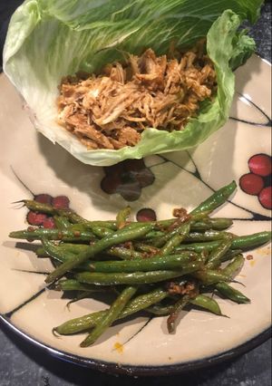 A picture of Asian inspired lettuce wrap with green beans.