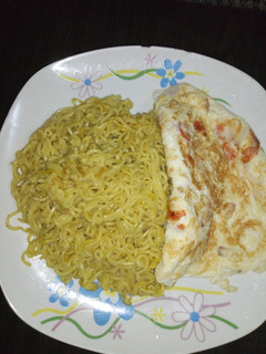 A picture of Spiced noodles and fried egg.