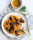 Honey and mustard pork meatballs with pumpkin tagliatelle topped with crispy sage