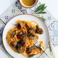 Honey and mustard pork meatballs with pumpkin tagliatelle topped with crispy sage A picture of Honey and mustard pork meatballs with pumpkin tagliatelle topped with crispy sage.