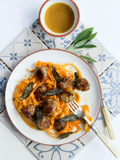 A picture of Honey and mustard pork meatballs with pumpkin tagliatelle topped with crispy sage.