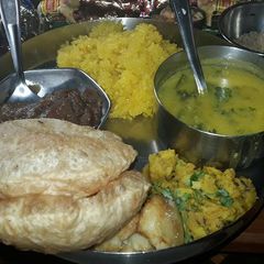 A picture of Meethe chawal,Teen dal Curry,Wheat flour Sheera.