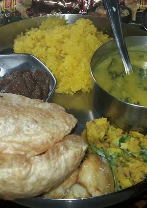 A picture of Meethe chawal,Teen dal Curry,Wheat flour Sheera.