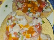 Una foto de ceviche de pescado con cebolla morada