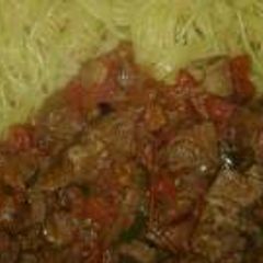 A picture of Stewed beef with spaghetti.