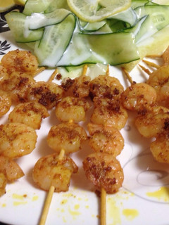 A picture of Shrimp Tikka with cucumber ribbon salad.