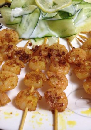 A picture of Shrimp Tikka with cucumber ribbon salad.