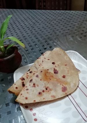 A picture of Aloo parantha with achar.