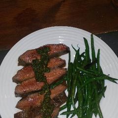 A picture of Flat iron steak with Italian salsa verde.