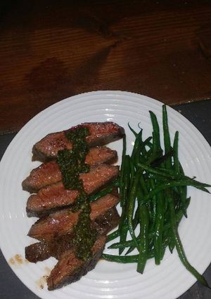 A picture of Flat iron steak with Italian salsa verde.