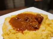 Una foto de polenta con salsa