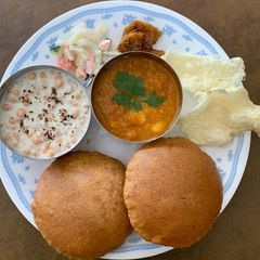 A picture of Traditional Thali(Bedmi puri,Aloo ki subji with Raita).