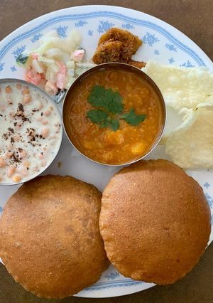 A picture of Traditional Thali(Bedmi puri,Aloo ki subji with Raita).
