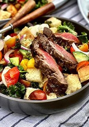 A picture of Grilled Wagyu Steak Panzanella Salad with Vinaigrette.