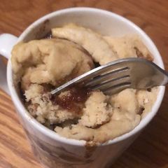 A picture of Cinnamon roll in a mug.