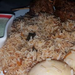 A picture of Egg biryani with beef roast.
