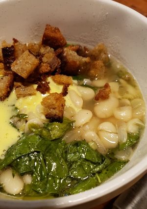 A picture of Rich Butter Beans with Greens, Toasted Bread, and Aioli.