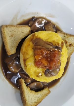 A picture of Scrambled Eggs with Mushrooms and Truffle Oil-Infused Broth.