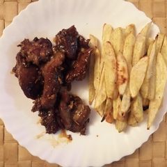 A picture of Baked Honey Garlic Goat Meat and Sweet Potato Fries.