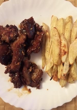 A picture of Baked Honey Garlic Goat Meat and Sweet Potato Fries.
