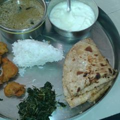 A picture of Puran Poli methi saag pakora ane amti.