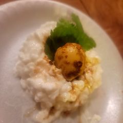 A picture of Honey Soy Spiced Quail Eggs, atop bed of Cottage Cheese or Rice.