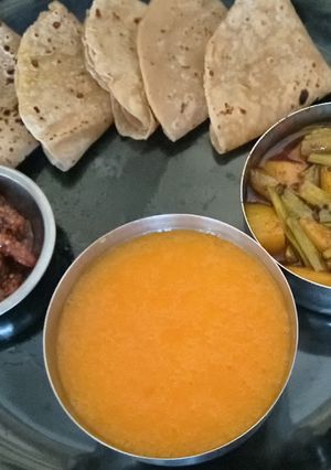 A picture of Tasty Unique Healthy Phulka Roti with Potato Cluster Bean Sabji and Mango Juice with Mango Pickle.