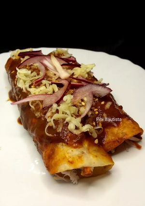 A picture of Chicken Enchiladas with Mole.