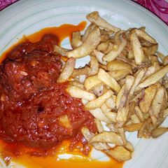 Fried Irish potatoes with fresh tomatoes sauce A picture of Fried Irish potatoes with fresh tomatoes sauce.