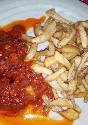 A picture of Fried Irish potatoes with fresh tomatoes sauce.