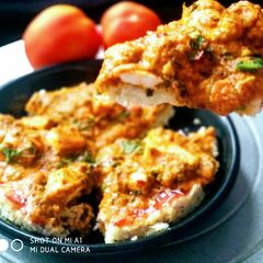 A picture of Fusion of Italian pizza and Punjabi butter panner.