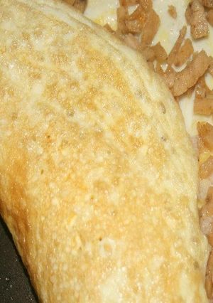 A picture of Stuffed omelette with Chicken salami.