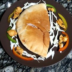 A picture of Chicken masala in pita bread.