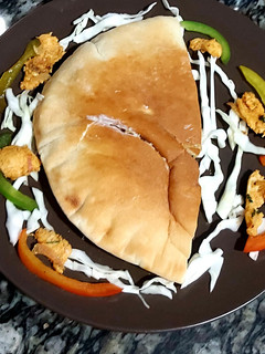 A picture of Chicken masala in pita bread.